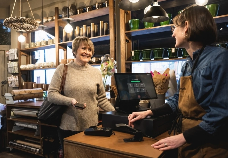 Lady making a payment at cash register